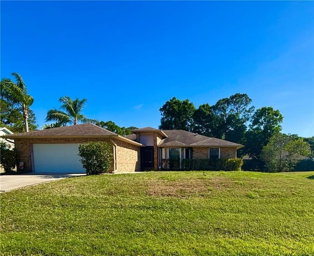 single story home featuring brick siding, driveway, a front yard, and a garage