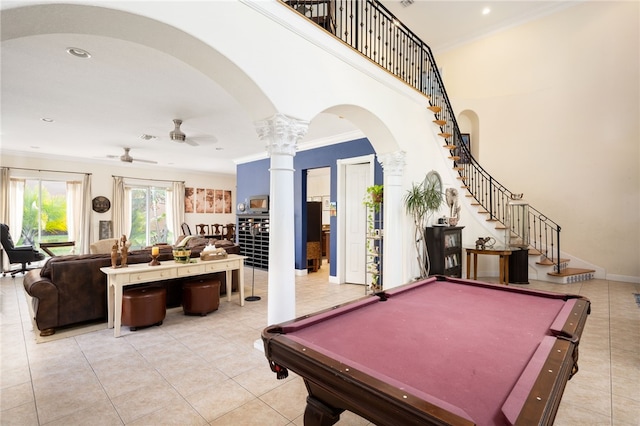 game room featuring ceiling fan, light tile patterned floors, crown molding, and decorative columns