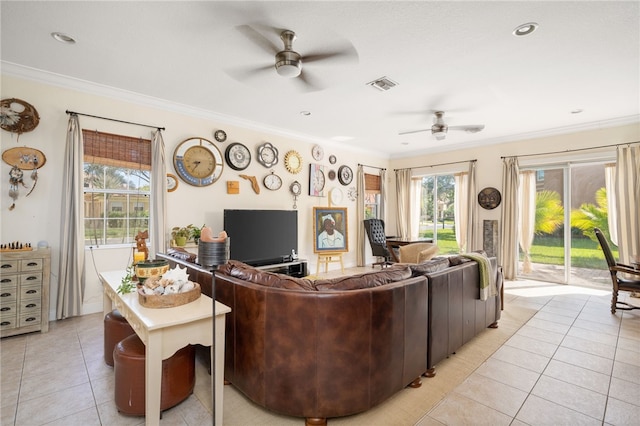 living room with light tile patterned flooring, ceiling fan, plenty of natural light, and crown molding