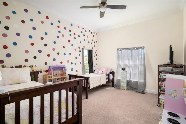 bedroom with carpet floors, ceiling fan, and crown molding