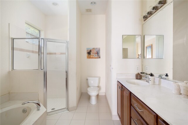 full bathroom with toilet, shower with separate bathtub, vanity, and tile patterned flooring