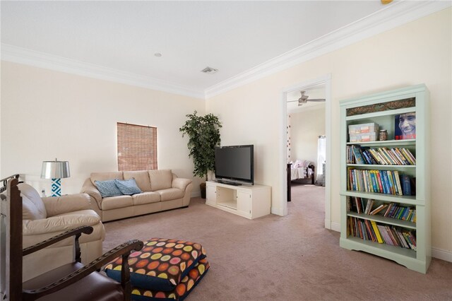 living room featuring ceiling fan, light colored carpet, and crown molding