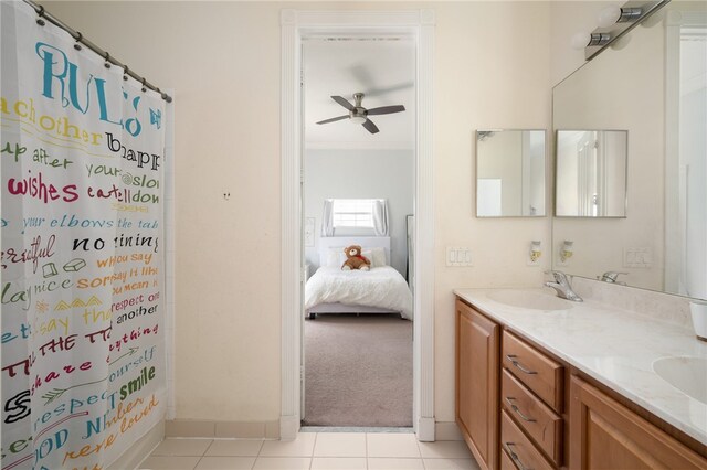 bathroom with a shower with shower curtain, ceiling fan, tile patterned floors, and vanity