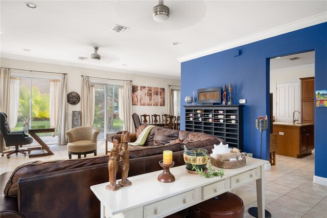 living room with ornamental molding, ceiling fan, and light tile patterned flooring