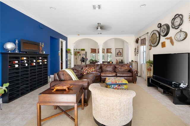 living room with ceiling fan, light tile patterned floors, and ornamental molding