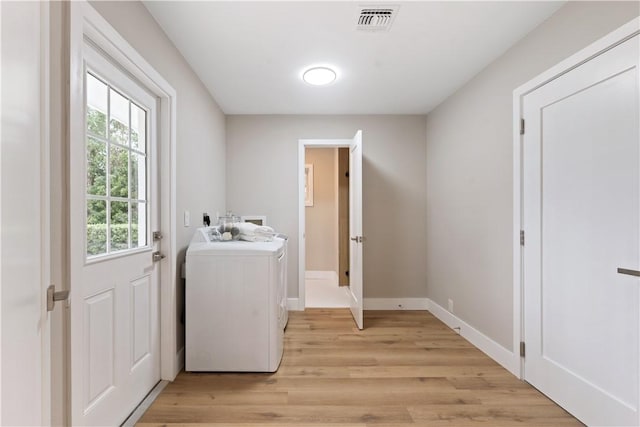 25 Park Ave, Vero Beach, FL 32960 - washroom featuring washer / clothes dryer, light wood-style floors, and baseboards