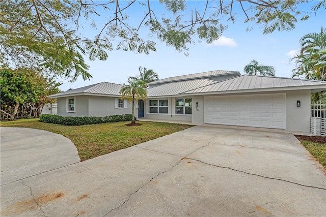 single story home featuring a garage and a front yard