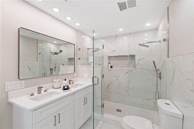 25 Park Ave, Vero Beach, FL 32960 - bathroom with toilet, a marble finish shower, double vanity, recessed lighting, and marble finish floors