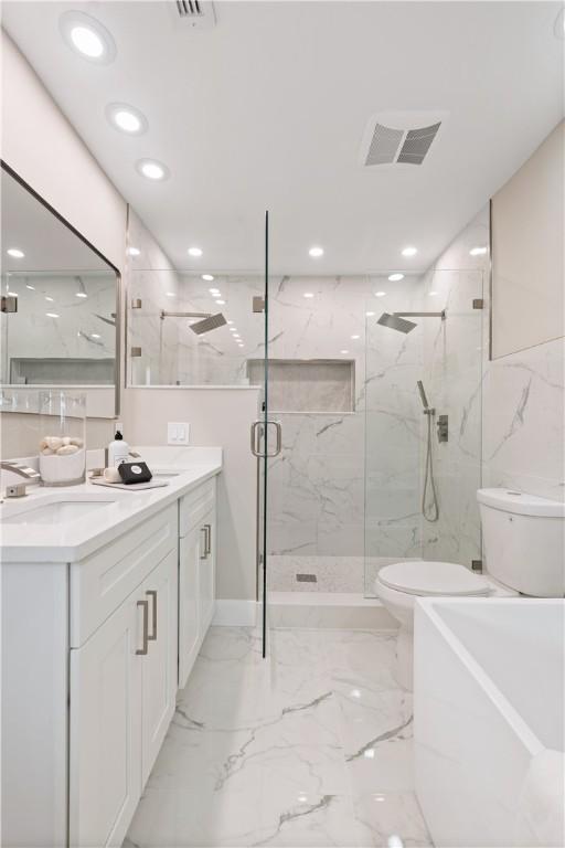 25 Park Ave, Vero Beach, FL 32960 - full bathroom featuring toilet, a marble finish shower, vanity, recessed lighting, and marble finish floors