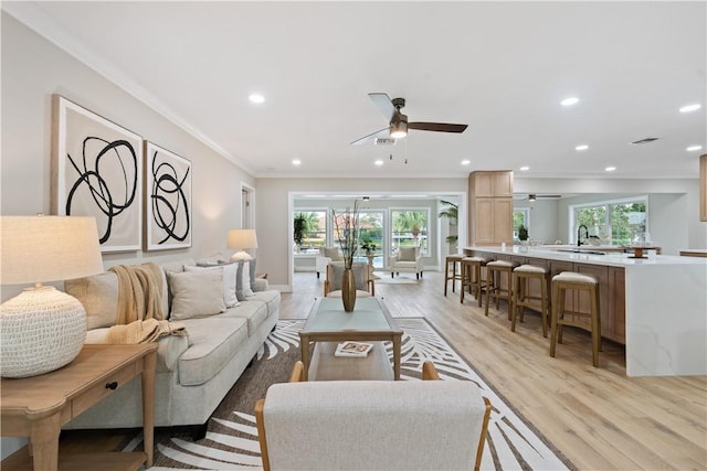 25 Park Ave, Vero Beach, FL 32960 - living room featuring ceiling fan, crown molding, light wood-style floors, and recessed lighting