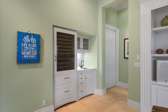 interior space with ornamental molding and sink