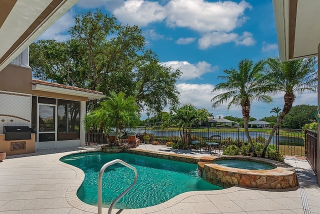 view of swimming pool featuring a sunroom, a patio area, a water view, and an in ground hot tub