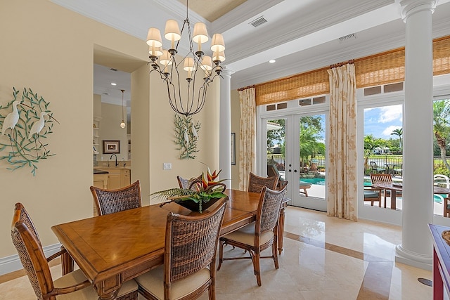 dining room featuring french doors, ornate columns, ornamental molding, sink, and a notable chandelier