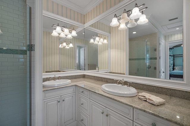 bathroom featuring vanity, a shower with shower door, and ornamental molding