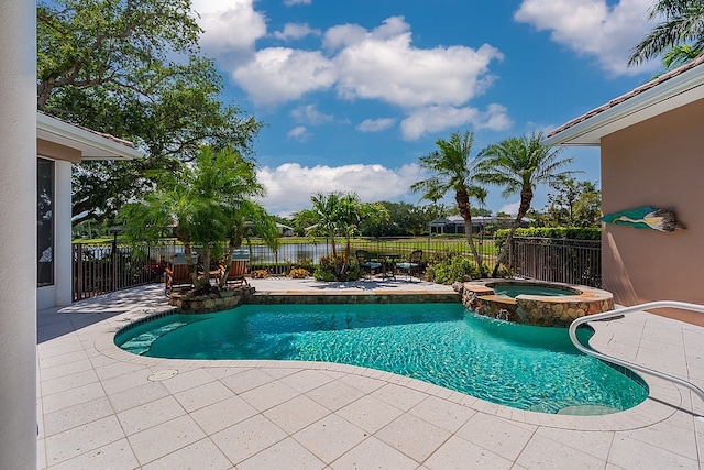 view of swimming pool featuring a patio area and an in ground hot tub