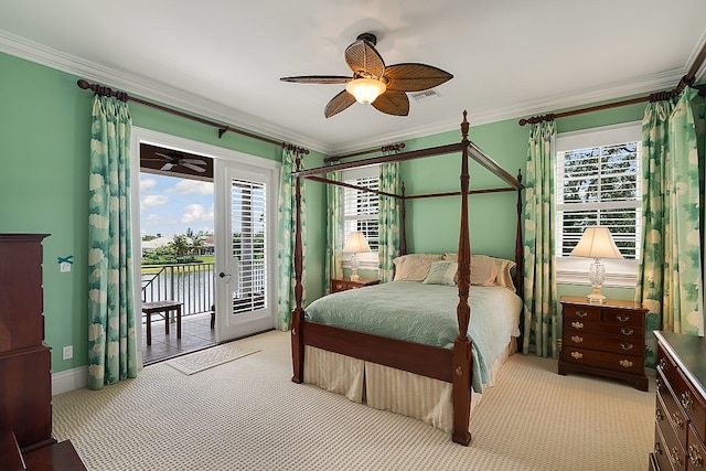 carpeted bedroom featuring access to outside, a water view, multiple windows, and ceiling fan