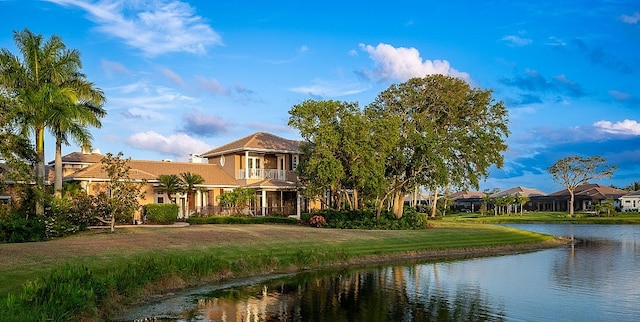 back of property featuring a water view