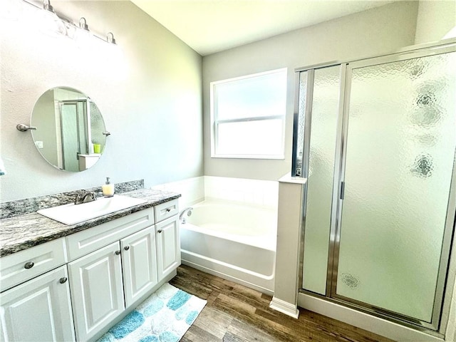 bathroom with vanity, hardwood / wood-style flooring, and separate shower and tub