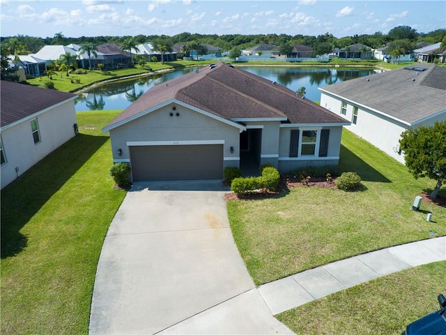 ranch-style home featuring a garage, a water view, and a front lawn