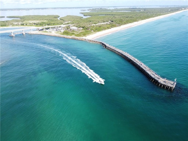 drone / aerial view featuring a water view and a view of the beach