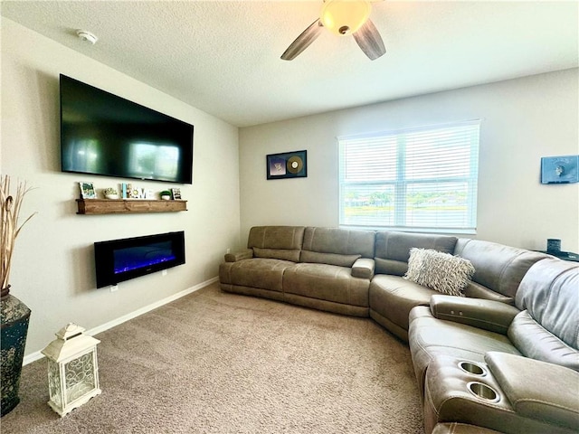 carpeted living room featuring ceiling fan and a textured ceiling