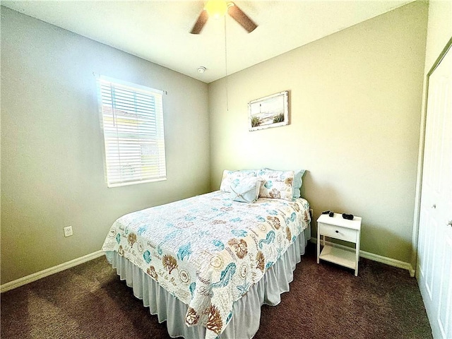 carpeted bedroom with ceiling fan and a closet