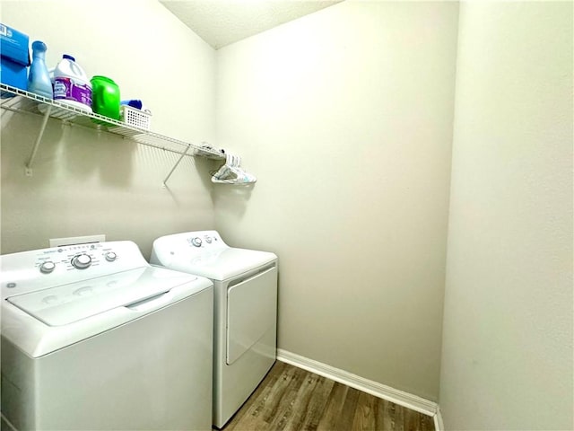 laundry area featuring washer and dryer and wood-type flooring