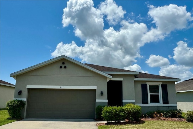 ranch-style home featuring a garage and a front lawn