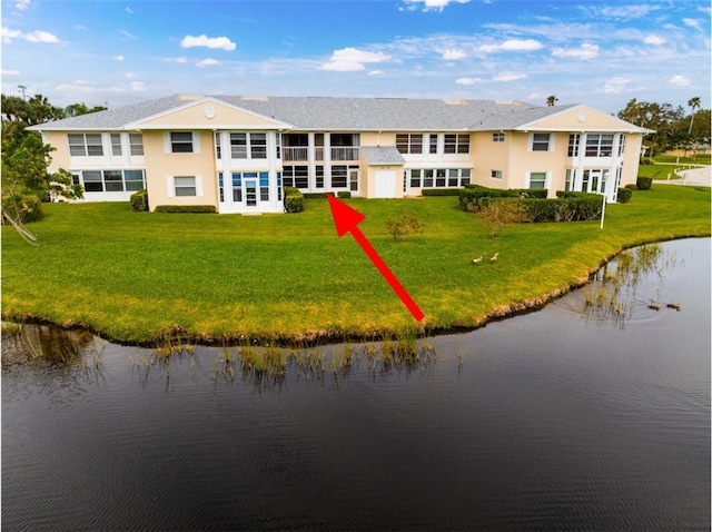 birds eye view of property with a water view