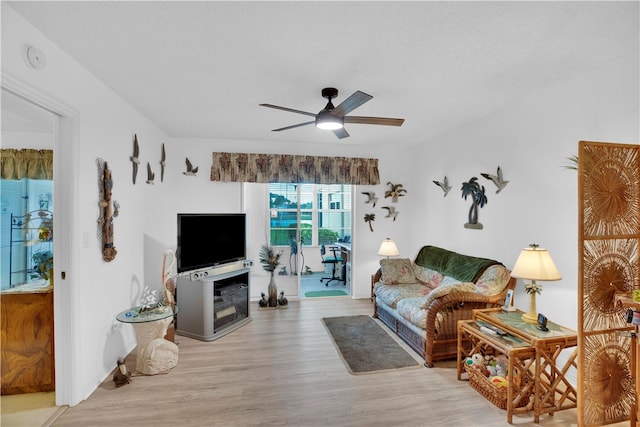 living room featuring ceiling fan and light wood-type flooring