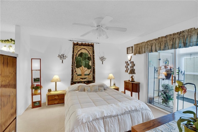 bedroom with access to exterior, light carpet, a textured ceiling, and ceiling fan