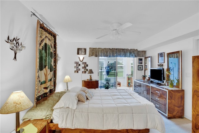 bedroom with ceiling fan and light carpet