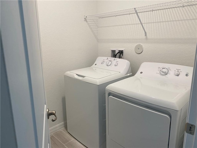 clothes washing area with washer and clothes dryer