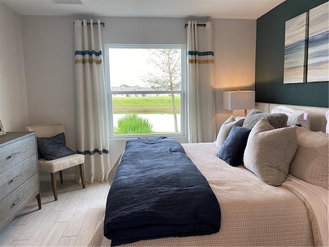 bedroom featuring multiple windows and light wood-type flooring