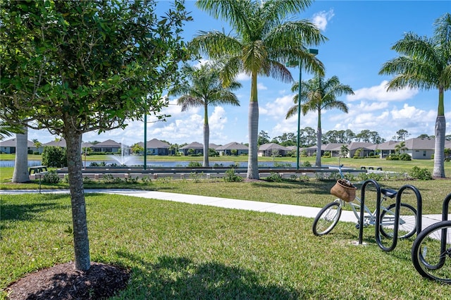 view of community with a yard and a water view