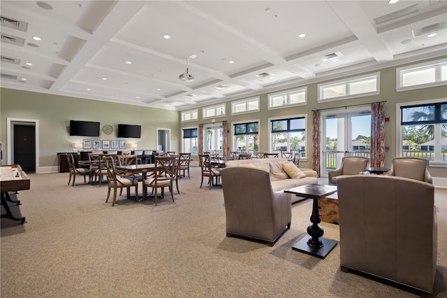 living room with beam ceiling, light colored carpet, a towering ceiling, and coffered ceiling