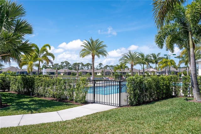 view of swimming pool featuring a yard