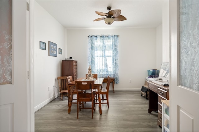 dining room featuring wood-type flooring and ceiling fan