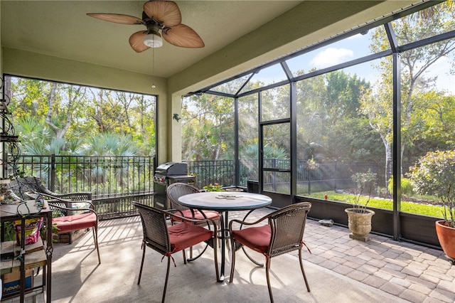 sunroom / solarium featuring ceiling fan and a wealth of natural light