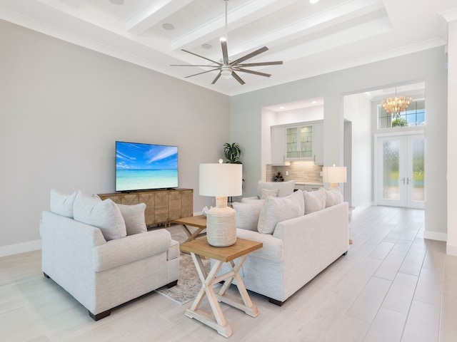 living room featuring ceiling fan with notable chandelier, beamed ceiling, crown molding, and french doors