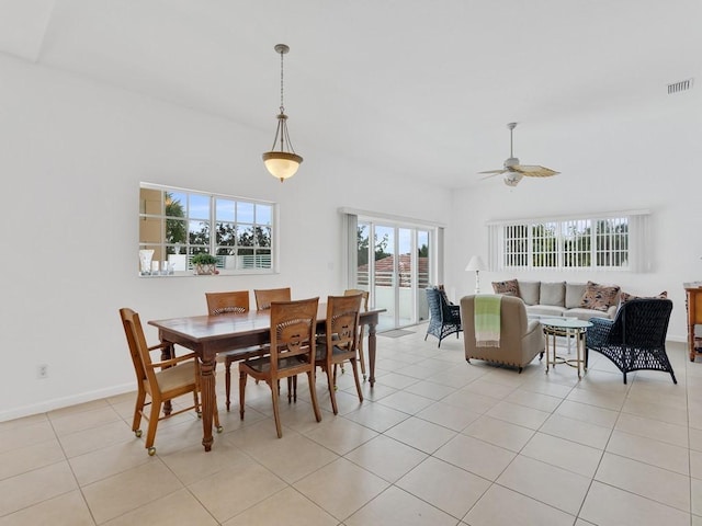 tiled dining area with ceiling fan