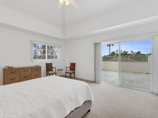 carpeted bedroom featuring multiple windows, access to exterior, and ceiling fan