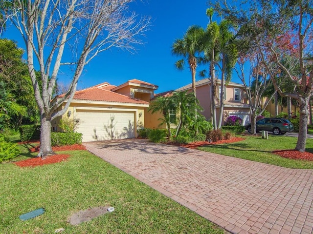 view of front of property with a front yard and a garage