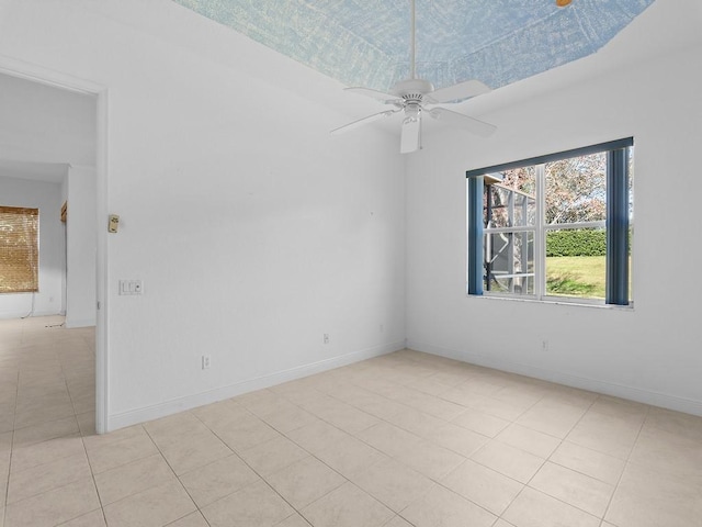 tiled empty room featuring ceiling fan