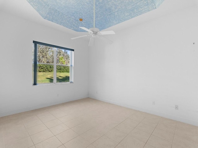 tiled spare room with ceiling fan