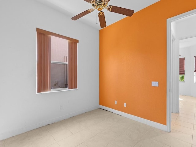 tiled empty room with ceiling fan