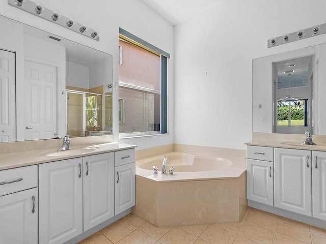 bathroom featuring tile patterned flooring, vanity, and plus walk in shower