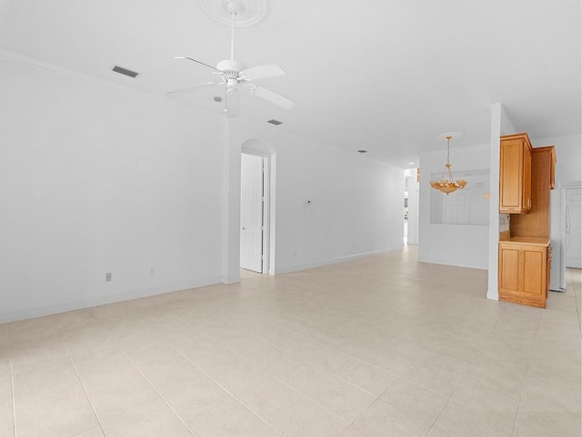 unfurnished living room featuring light tile patterned floors and ceiling fan with notable chandelier