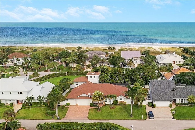 bird's eye view with a water view and a beach view