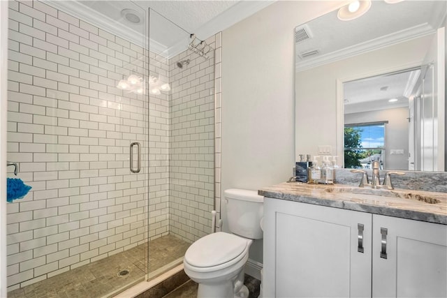 bathroom featuring vanity, a shower with door, tile patterned floors, toilet, and ornamental molding